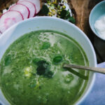 Green soup with goat's curd